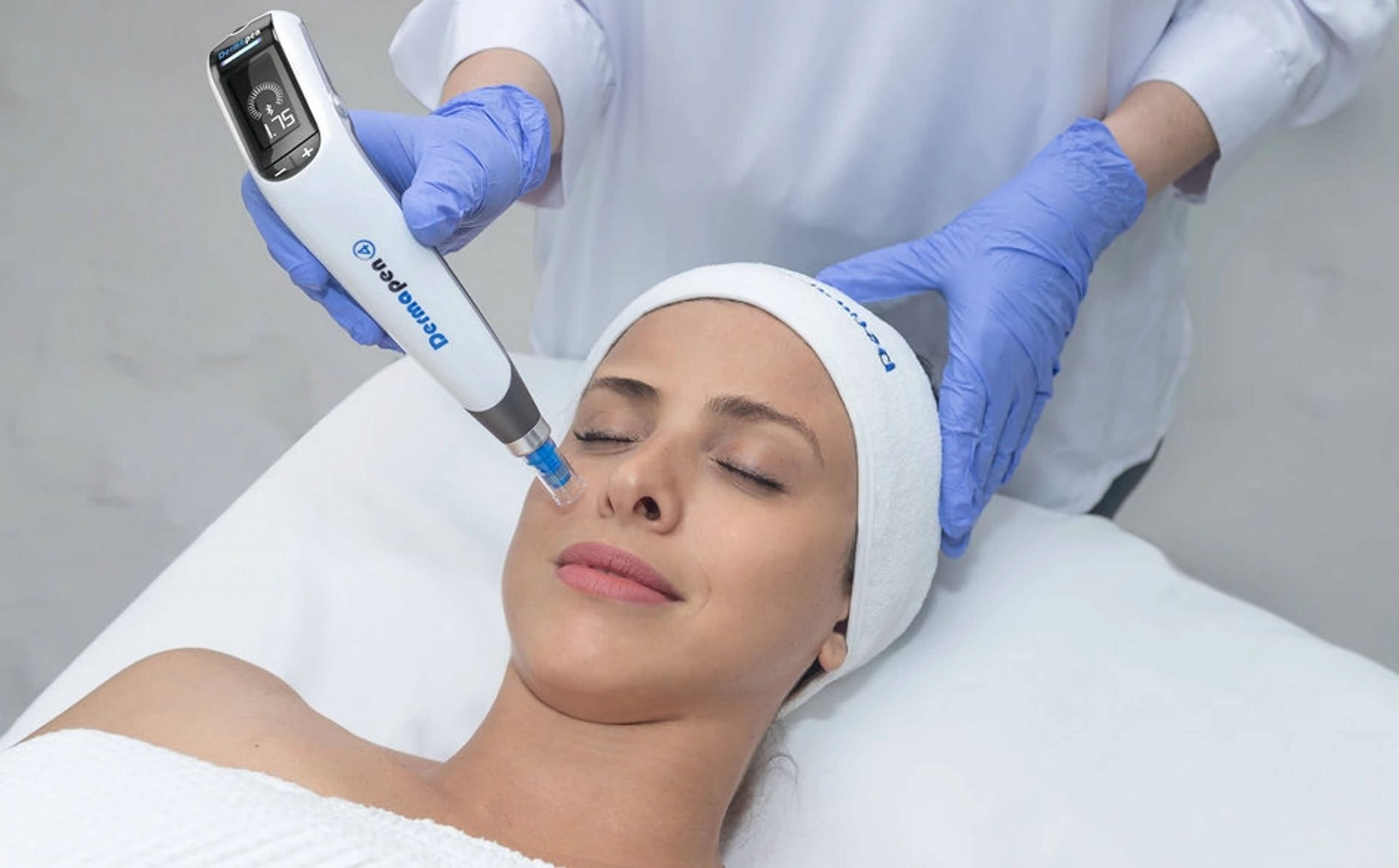 A doctor performing facial treatment on a patient, using Dermapen 4.