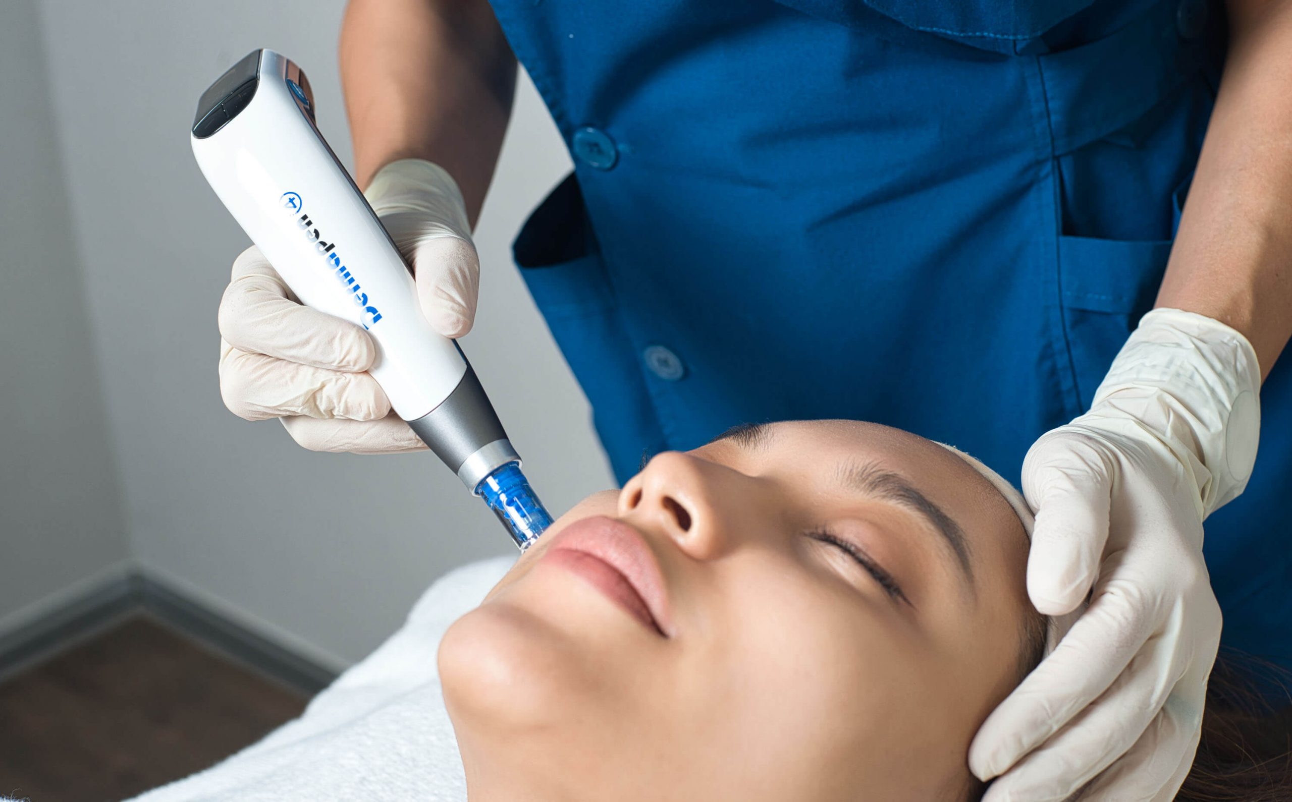 An aesthetician performing treatments on a patient's face, using Dermapen 4.